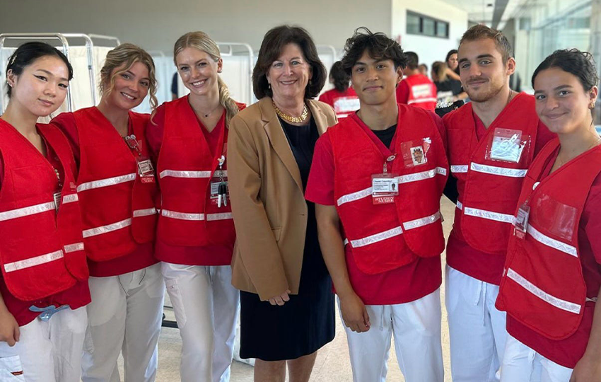 Nursing students posing for a picture with Dean Patricia Bruckenthal. 