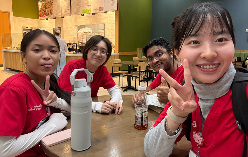 A group of nursing students sitting at a table.
