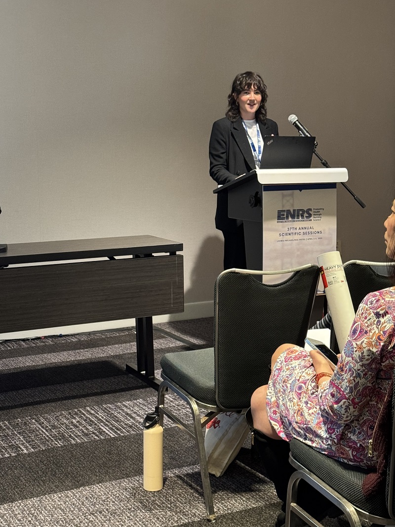 Dr. Clare Whitney presenting her podium on Aligning Goals in Heatlhcare’s Hierarchical Systems: A Data–Driven Theory on Interprofessional Communication in the Healthcare Setting